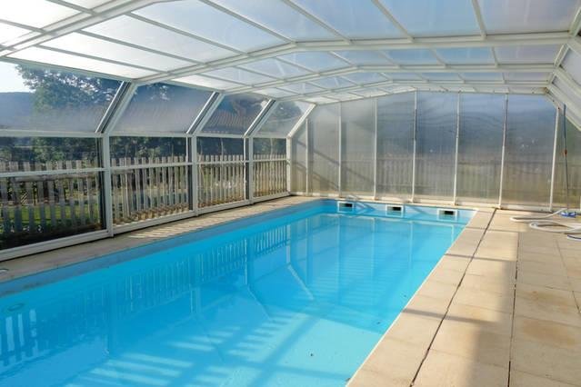 The gîte pool under its glass shelter