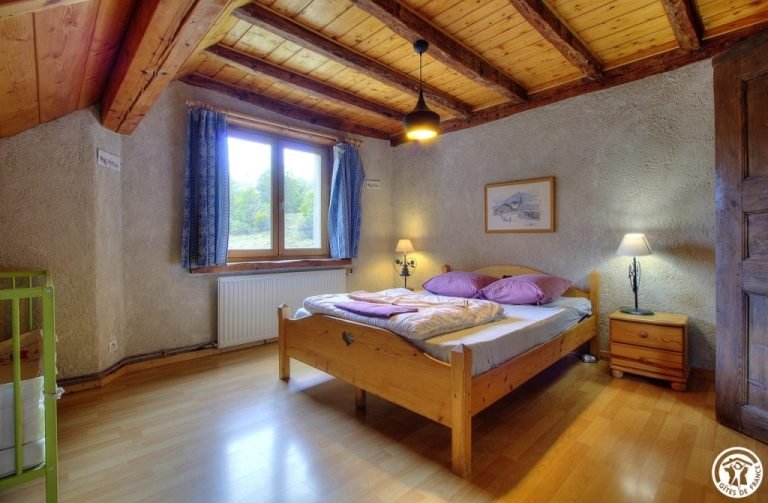 Bedroom with double bed and blue curtains