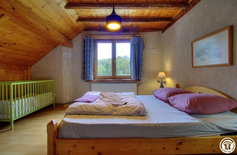 Bedroom with double bed and baby cot